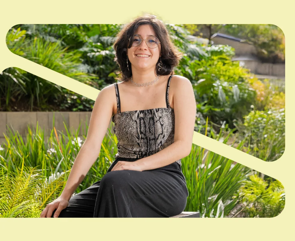 Karla Cruz sonriendo sentada en un jardín